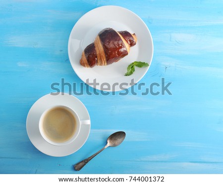 A Chocolate Croissant And Cup Of Coffee Are The Perfect Combination For Breakfast Or A Chocolate Croissant And Cup Of Coffee Are The Perfect Combination For Breakfast Or