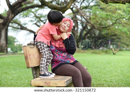 Image result for Malaysian Muslim lady hugging her child