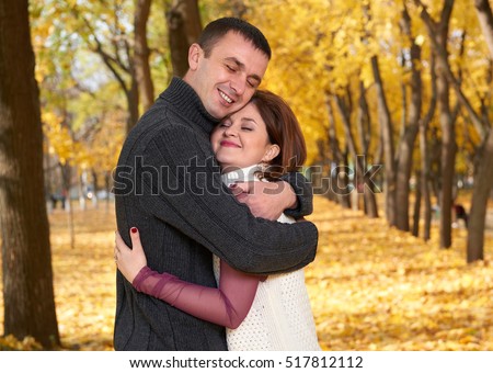 https://thumb9.shutterstock.com/display_pic_with_logo/183547/517812112/stock-photo-romantic-people-happy-adult-couple-embrace-in-autumn-city-park-trees-with-yellow-leaves-bright-517812112.jpg