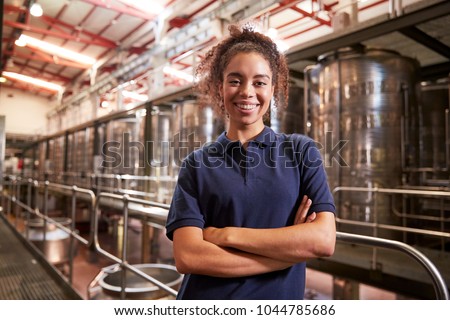 Portrait of young mixed race woman working at a wine factory