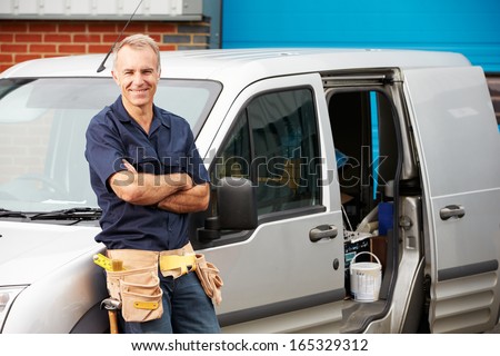 Plumber Or Electrician Standing Next To Van