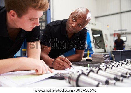 Engineer And Apprentice Planning CNC Machinery Project