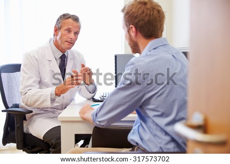 Male Patient Having Consultation With Doctor In Office
