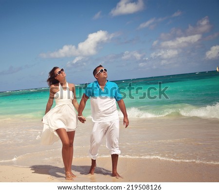 https://thumb9.shutterstock.com/display_pic_with_logo/1883903/219508126/stock-photo-couple-walking-on-beach-young-happy-couple-walking-on-beach-smiling-holding-hands-219508126.jpg