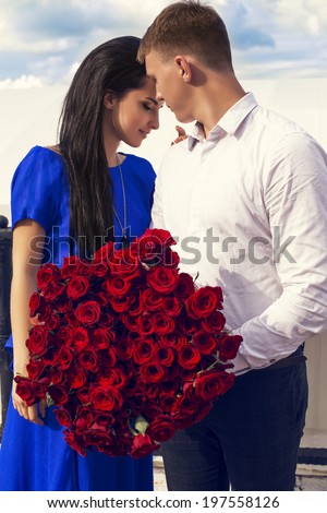 https://thumb9.shutterstock.com/display_pic_with_logo/1904156/197558126/stock-photo-beautiful-couple-dating-people-couple-with-a-big-bouquet-of-red-roses-197558126.jpg