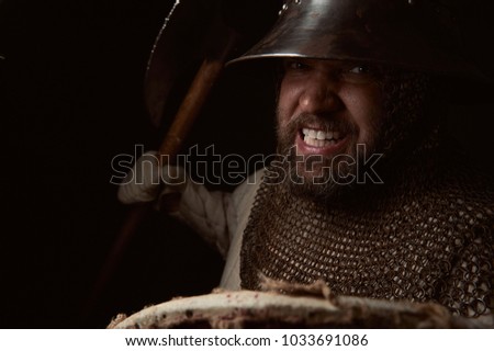Medieval infantry man charging for attack. Historical re-enactment scene with authentic clothing and props