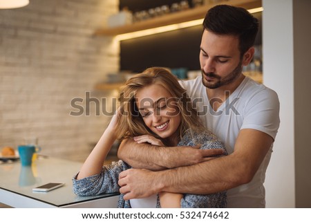 https://thumb9.shutterstock.com/display_pic_with_logo/1927106/532474642/stock-photo-beautiful-couple-enjoying-a-hug-at-home-in-the-kitchen-532474642.jpg