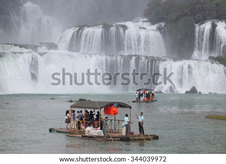 Cao Bang, Vietnam - Nov 24, 2015: Tourist visit and charm Ban Gioc waterfall on paddling boat. The huge waterfall is on the border line of Vietnam and China.