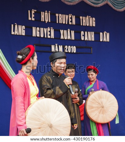 Bac Ninh, Vietnam - Mar 24, 2010: Vietnamese popular civilian artist in traditional costume singing traditional melody called Quan Ho Bac Ninh in occasion of a local folk free entrance festival day.