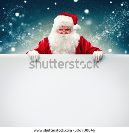 Happy Santa Claus holding blank advertisement banner background with copy space. Smiling Santa Claus pointing in white blank sign. Christmas theme, sales