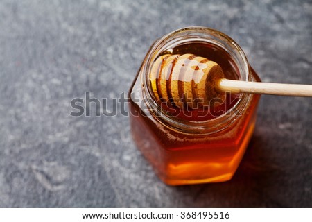 Honey in a pot or jar on kitchen table, top view