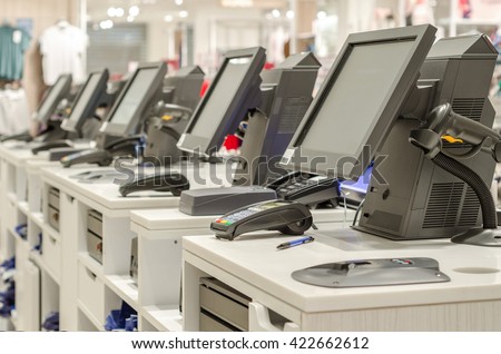 Electronic cash or modern cashier standing at the counter in a large empty store dressing room