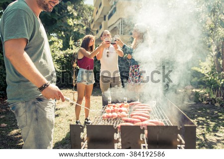 Group of friends making barbecue in the backyard. concept about good and positive mood with friends