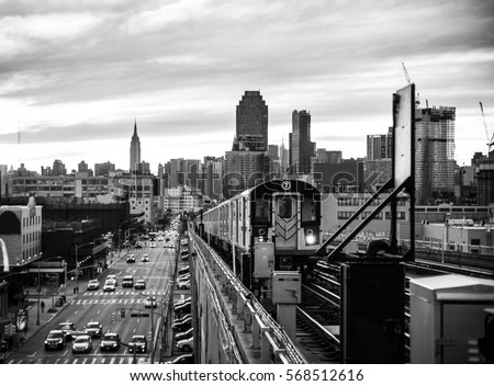 Subway train in New York at sunset and Manhattan cityscape view