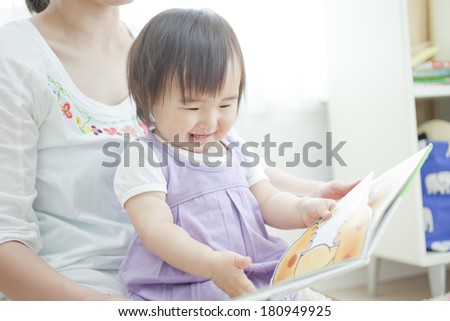 Japanese girl reading a picture book to her mother,