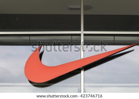 Milan, Italy - April 15, 2016: Nike logo on a face of a store. Nike is an American company specializing in sports equipment based in Beaverton, Oregon, USA
