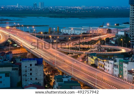 Hanoi cityscape. Aerial view of enter way to Vinh Tuy bridge at twilight