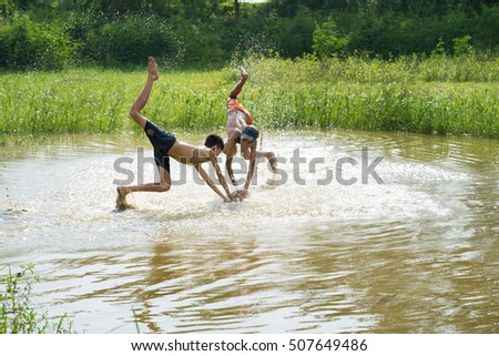 Bac Ninh, Vietnam - May 29, 2016: Children catching fish by fishing bamboo trap - the old traditional way, on pond in Bac Ninh province