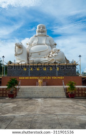 My Tho, Vietnam - August 11, 2015: large seated Buddha sculpture in the Vinh Trang Temple, a 19th century Buddhist temple in My Tho in the province of Tien Giang.
