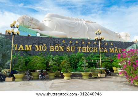 My Tho, Vietnam - August 11, 2015: Large reclining Buddha statue in Vinh Trang Temple, a 19th century Buddhist temple in My Tho in the province of Tien Giang.