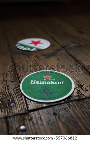 AMSTERDAM, HOLLAND - April 24, 2016.: Beer mats from Heineken Lager Beer in vintage background , it was first brewed by Gerard Adriaan Heineken in 1873