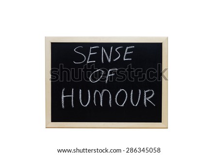 SENSE OF HUMOUR written with white chalk on blackboard.