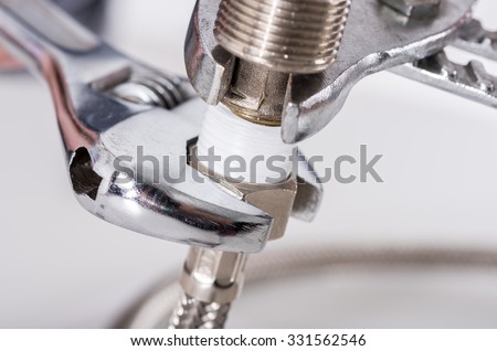 Plumber screwing plumbing fittings, closeup
