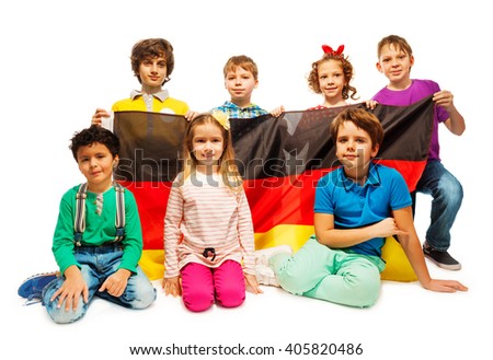 Group of seven children sitting with a German flag