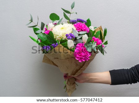 https://thumb9.shutterstock.com/display_pic_with_logo/2166254/577047412/stock-photo-woman-hand-holding-flowers-bouquet-of-flowers-for-congratulations-577047412.jpg