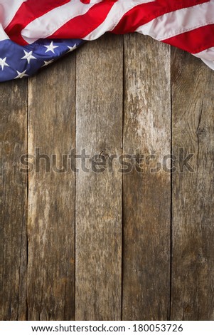 An American Flag Lying On Aged Weathered Rustic Wooden Background An American Flag Lying On Aged Weathered Rustic Wooden Background