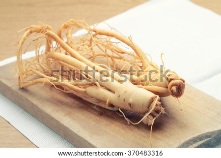 Korean ginseng on wood background - vintage filter.