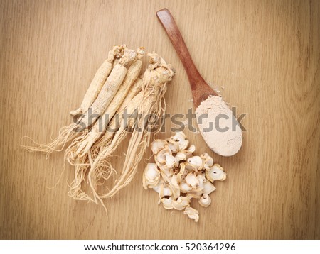 Korean ginseng powder,Dry Ginseng Roots on wood background - vintage filter.