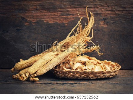 Korean dry ginseng roots on wood background - vintage filter.