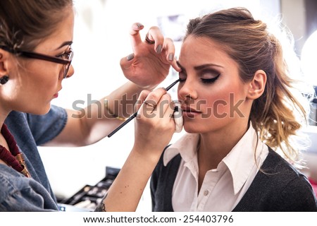 Make-up artist work on her friend.Real people.