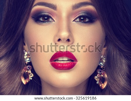 Beautiful woman with arabic make-up, red lips and curls. Beauty face. Insta Color