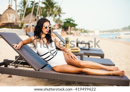 https://thumb9.shutterstock.com/display_pic_with_logo/2282717/419499622/stock-photo-beautiful-sexy-amazing-woman-brunette-lying-on-brown-chaise-lounge-on-the-beach-wearing-a-419499622.jpg