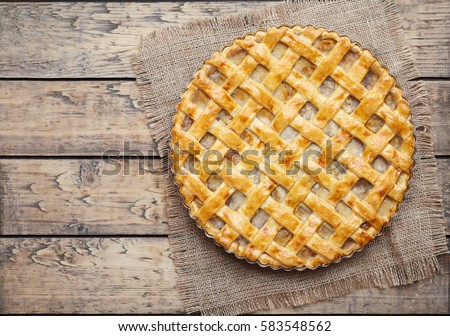 Apple Pie Tart With Raisins Nuts And Cinnamon On Vintage Wooden Background Texture Traditional Apple Pie Tart With Raisins Nuts And Cinnamon On Vintage Wooden Background Texture Traditional