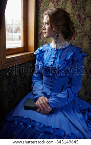 stock photo young woman in blue vintage dress late th century sitting with book in coupe of retro railway 345149645
