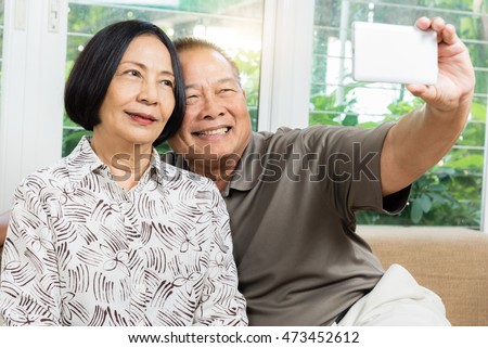 https://thumb9.shutterstock.com/display_pic_with_logo/2317913/473452612/stock-photo-happy-senior-asian-couple-smiling-and-taking-selfie-by-mobile-smart-phone-at-home-473452612.jpg