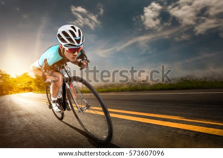 Asian men are cycling road bike in the morning.downhill