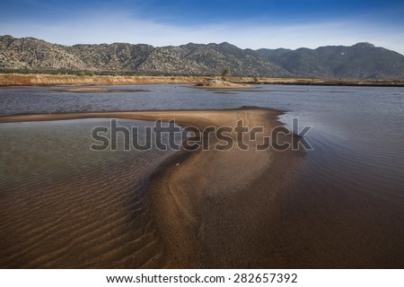 Mountainous Coastline at Ca Na, in the foreground, an artificial lake for salt extraction, Ninh Thuan, Vietnam