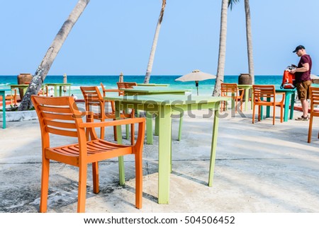 Phu Quoc Island, Kien Giang, Vietnam 11 March 2016: wooden furniture stand out side of a home stay in SAO Beach in Phu Quoc Island, near a man foreign tourist