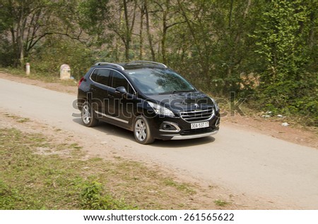Bac Giang, Viet Nam - March 17, 2015: A SUV Peugeot 3008 car running on the road in Vietnam