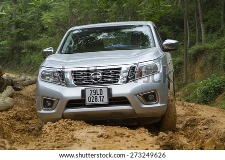 Tuyen Quang, Viet Nam - April 23, 2015: Nissan NP300 Navara car running on the mud road in Vietnam