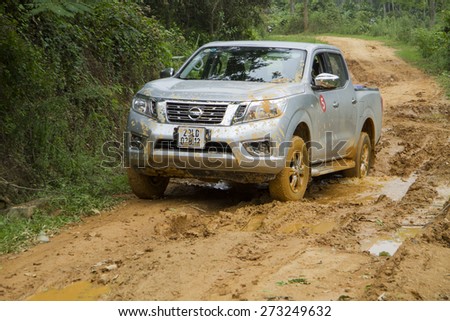 Tuyen Quang, Viet Nam - April 23, 2015: Nissan NP300 Navara car running on the mud road in Vietnam