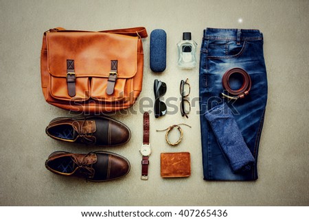 Men's casual outfits with accessories on gray grunge background