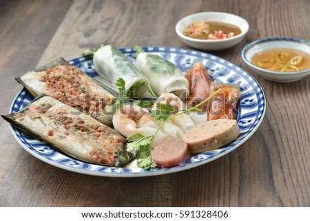Combo of mix Hue cake: banh beo, banh bot loc, banh nam (Hue cakes) eaten along with fish sauce.