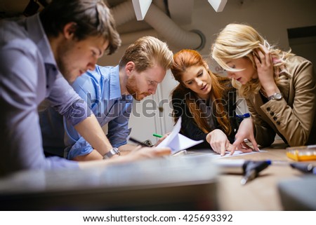 Creative workers designing and planing together in workshop