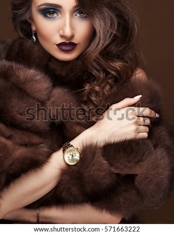 https://thumb9.shutterstock.com/display_pic_with_logo/2429303/571663222/stock-photo-luxury-elegant-woman-in-fur-coat-golden-earrings-and-watches-glamour-beautiful-look-rich-lady-571663222.jpg