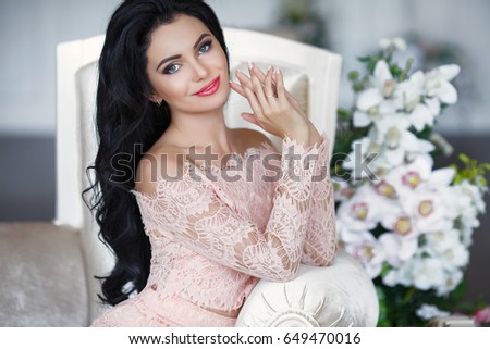 https://thumb9.shutterstock.com/display_pic_with_logo/2457938/649470016/stock-photo-elegant-brunette-woman-in-beige-lace-dress-posing-on-sofa-beautiful-fashion-model-with-long-dark-649470016.jpg